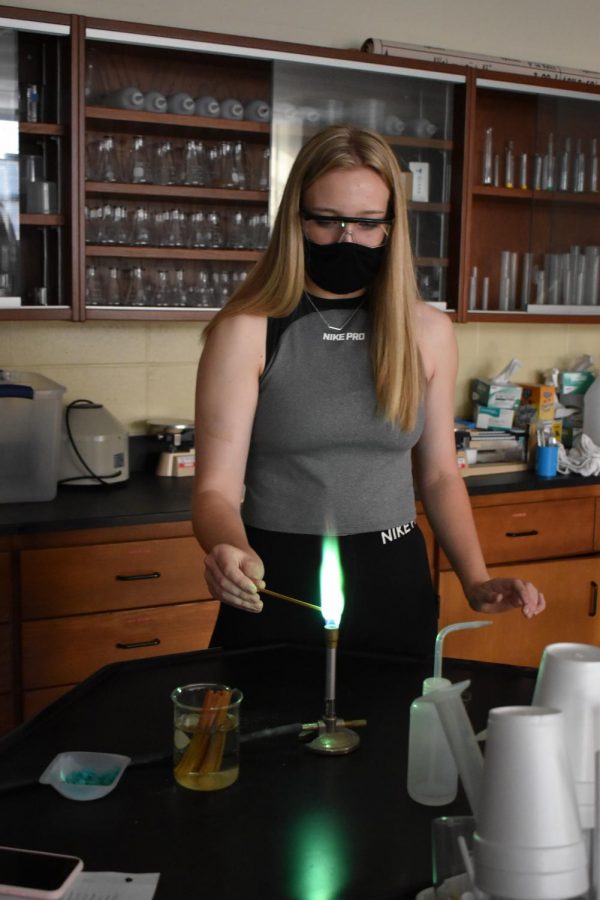Hana Dingman participates in chemistry flame lab.