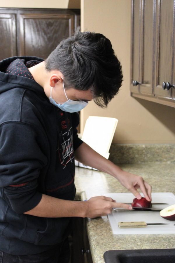 Eric Lejune practices knife skills in food safety and nutrition.