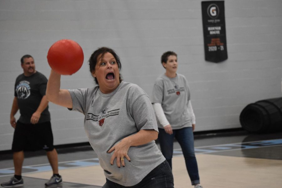 Aiming to launch her ball, AP U.S. History and Current Events teacher Kristi Waller plays a game of dodgeball against students during the pep rally on Nov. 30