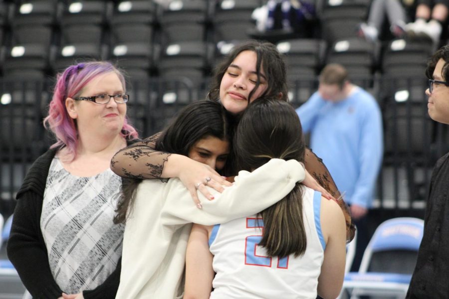 Bella Galdamez (12) embraces Khushi Bhanot (11) and Felicity Suggs (11) on Maverick basketball senior night. 