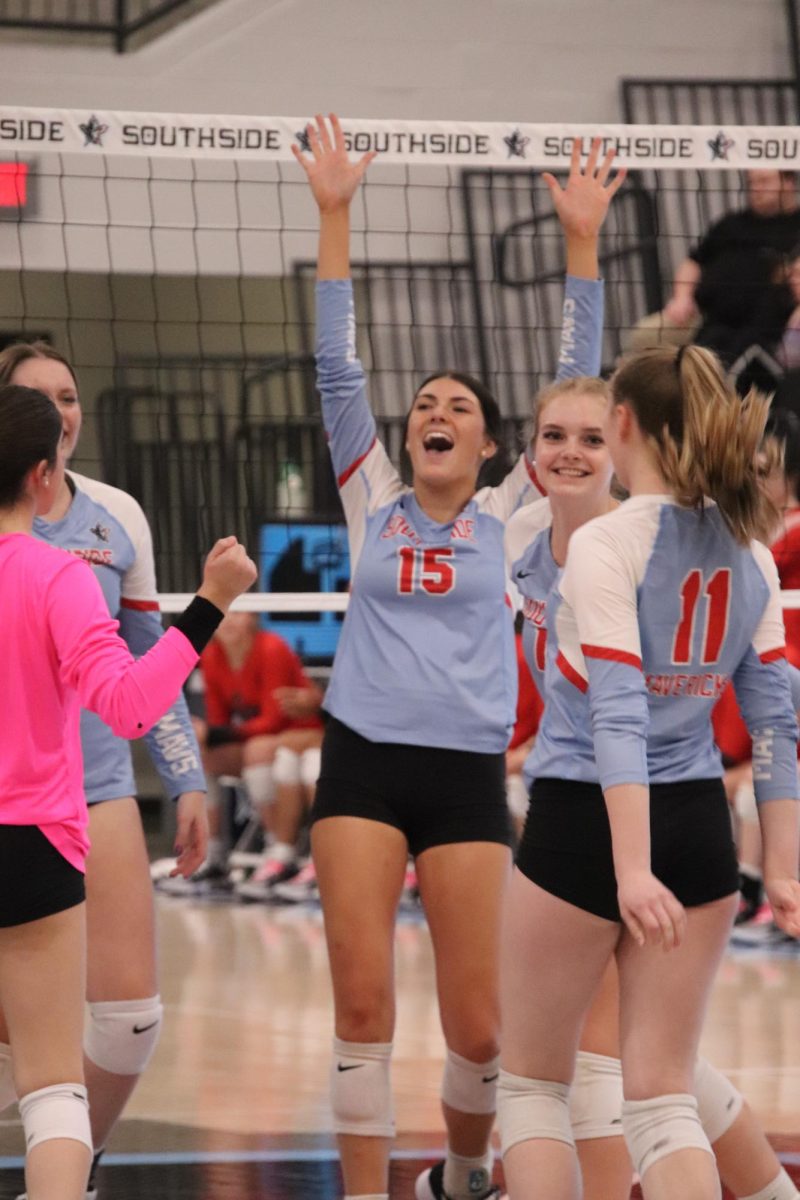 Senior Karlie Biggs celebrates with her team during their winning match over Northside at home.