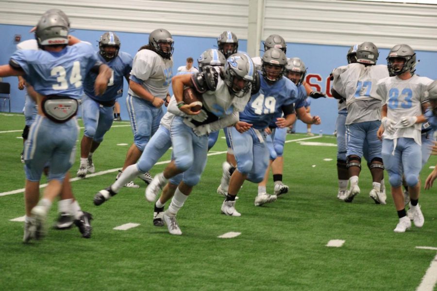 Football Team practices for upcoming season.