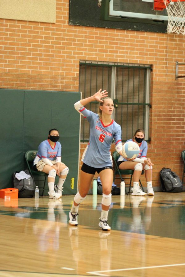 Hannah Hogue serves during volleyball game against Northside.