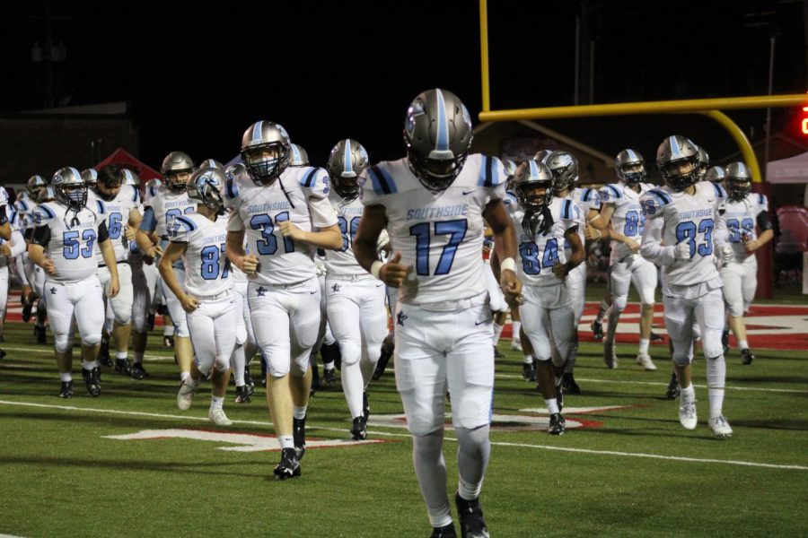 Football team runs out during first game of the season.