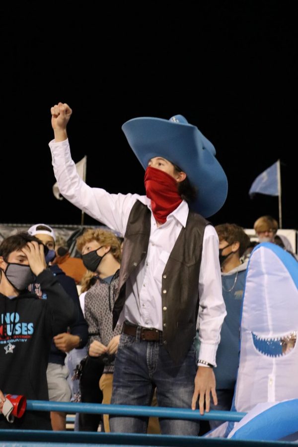 Mascot Braxton Waller cheering on the football team in the student section.