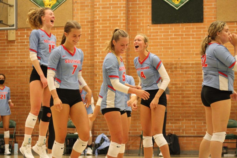 Volleyball team celebrates score in game against Bentonville.