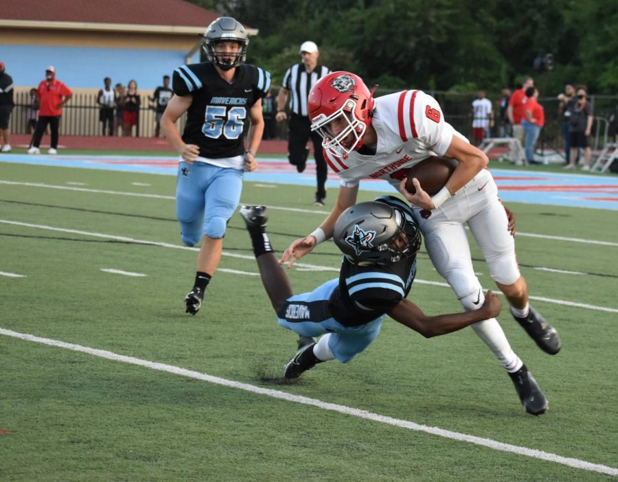 Strong safety Devin Huggins takes down quarterback Walker Catsavis during the first quarter of the home opener.