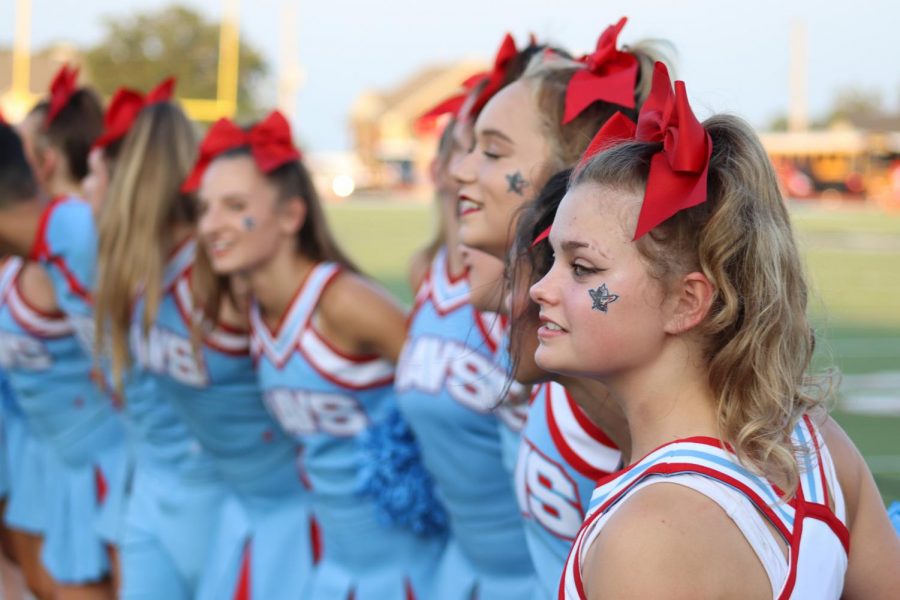 Junior Madison Kinsey sways with her squad before the game on Aug. 26 to the Alma Mater.