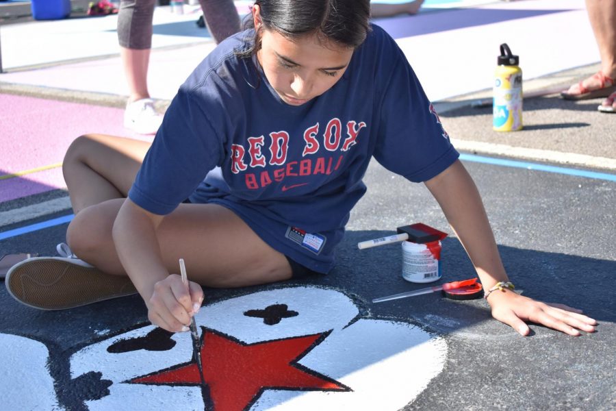 Senior Kiara Smiley paints spot 89 on Sept. 18. Smiley's design included a frog wearing a cowboy hat.