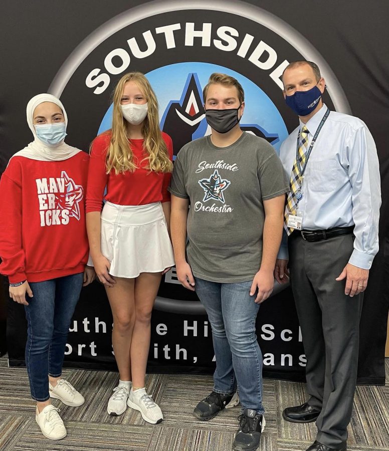 Seniors Leen Samman, Emma Paulus, and Jedidiah Lightner received recognition as National Merit Semi-finalists from principal Jeff Prewitt.