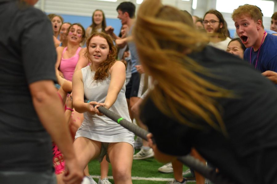 Representing the White team, senior Ellie Bunnell pulls the rope during a game of tug of war on Oct. 13.