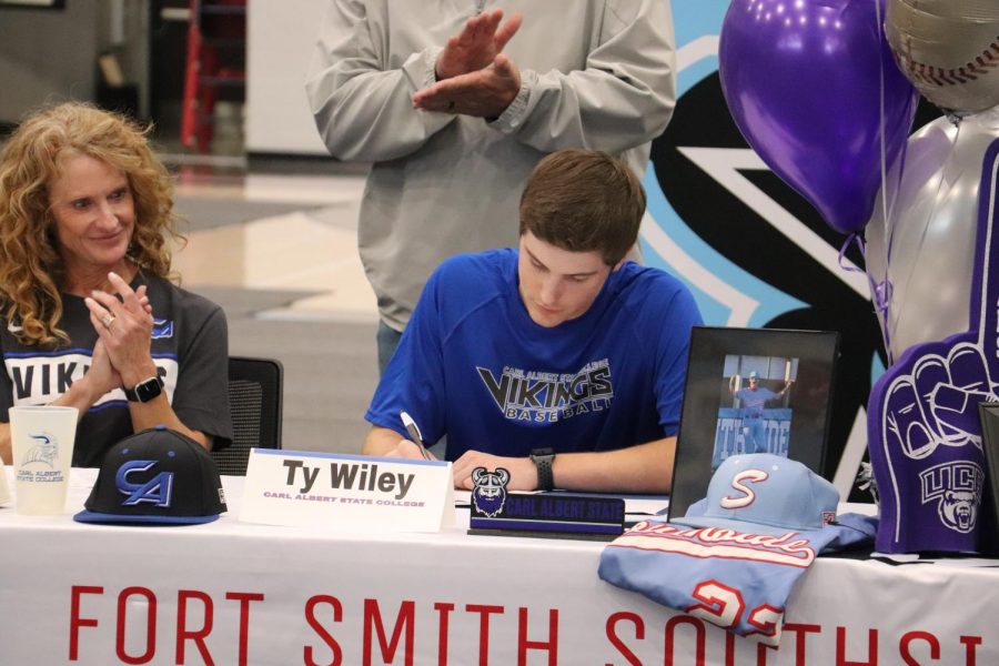 Senior Ty Wiley signs to continue his baseball career at Carl Albert State College.