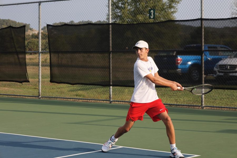 Sophomore Ryder Mack swings for the point for Maverick Tennis.