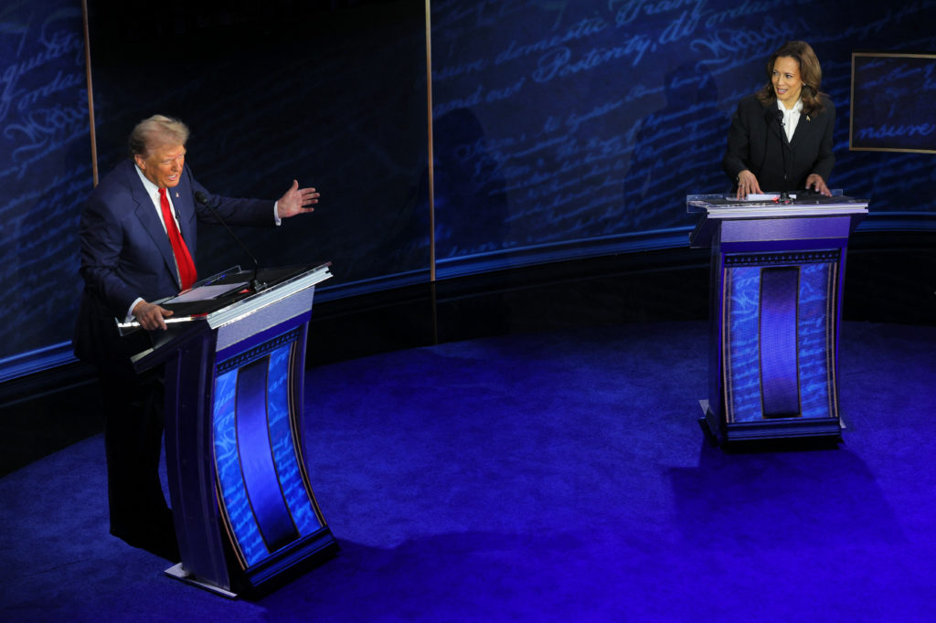 Republican presidential nominee, former U.S. President Donald Trump speaks as Democratic presidential nominee, U.S. Vice President Kamala Harris listens as they attend a presidential debate hosted by ABC in Philadelphia, Pennsylvania, U.S., September 10, 2024. REUTERS/Brian Snyder