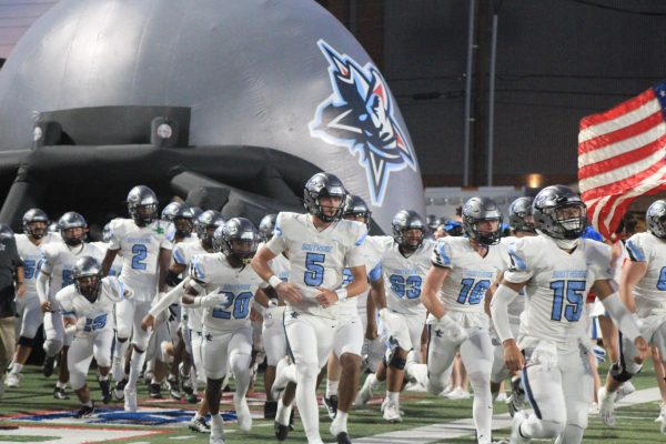 Southside football players charge the field as they prepare for the upcoming "battle"