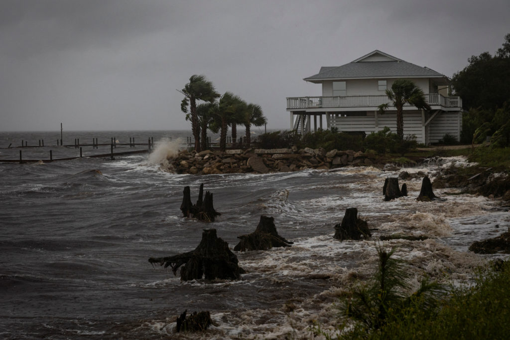 Waves impact a house seawall as Hurricane Helene intensifies before its expected landfall on Florida’s Big Bend, in Eastpoint, Florida, U.S. September 26, 2024.  REUTERS/Marco Bello