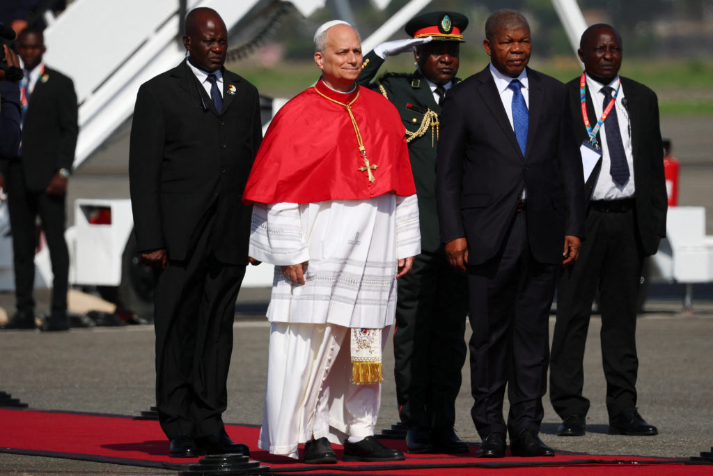 Pope Leo XIV is welcomed by Angolan President Joao Lourenco upon his arrival at Quatro de Fevereiro International Airport to begin his apostolic journey to Angola, in Luanda, Angola, April 18, 2026. REUTERS/Guglielmo Mangiapane